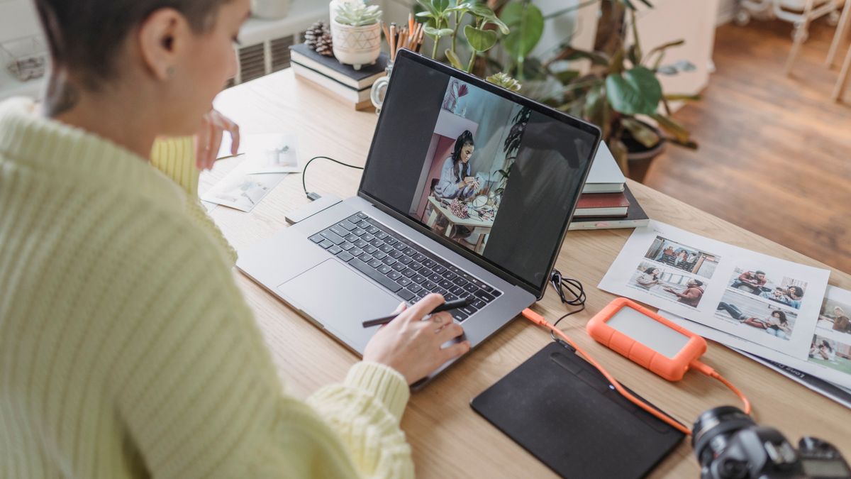 Editing a photo with AI photo editing software on a laptop