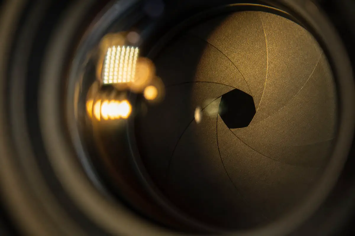 Close-up of camera lens aperture blades forming the opening that controls depth of field